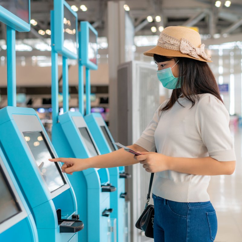 a flyer uses a kiosk at an airport