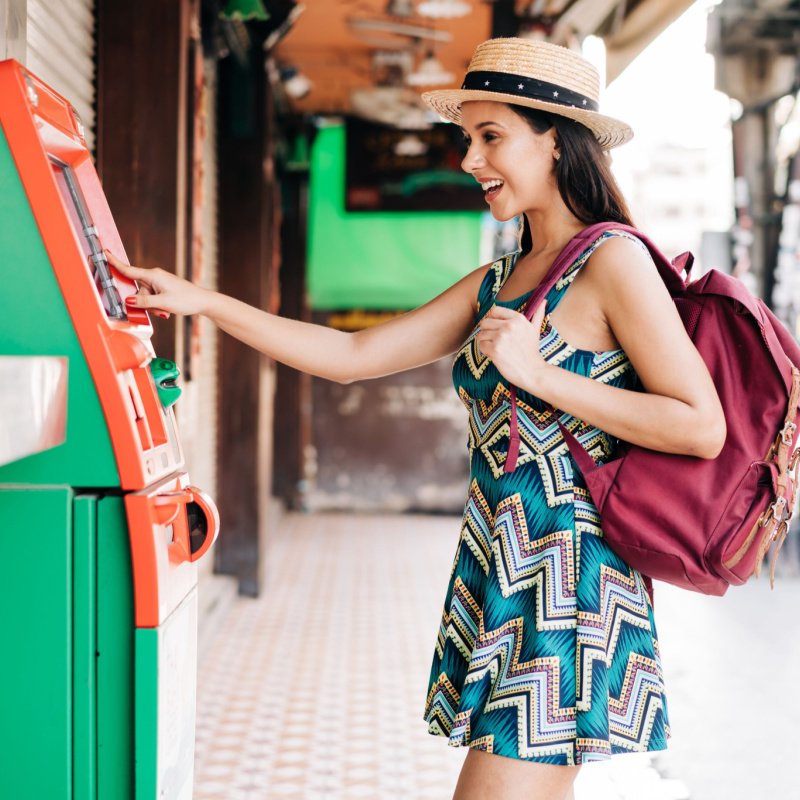 a woman uses an atm