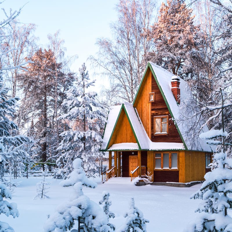 Wooden House With The Lights On In A Snowy Setting, Winter Travel