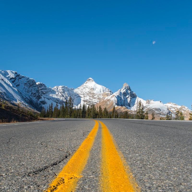 Road And Snowy Mountains On The Background