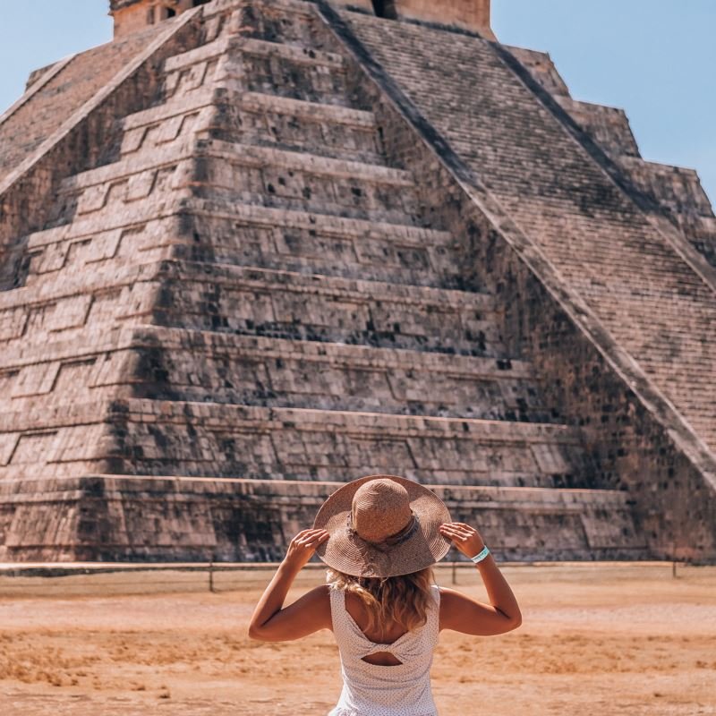 Woman facing mayan ruins in Mexico, number one on the list of friendliest destinations