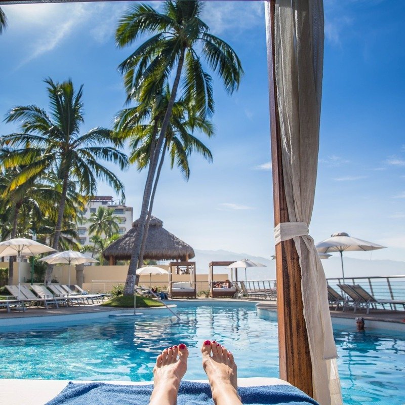 Female Tourist In A Cabana Style Resort In A Tropical Location, Caribbean, Beach Vacation