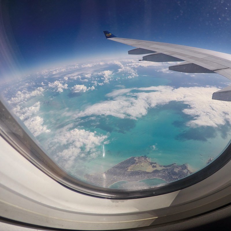 View Of An Island From Passenger Seat On Airplane