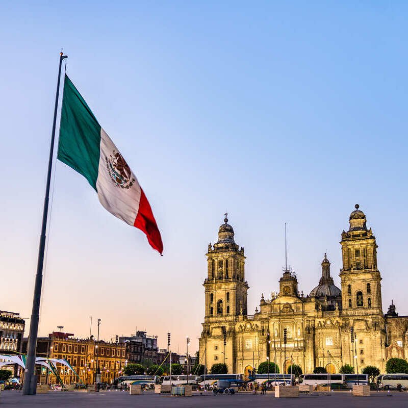 Flagpole With Mexican Flag Flying Before Metropolitan Cathedral In Mexico City, Mexico