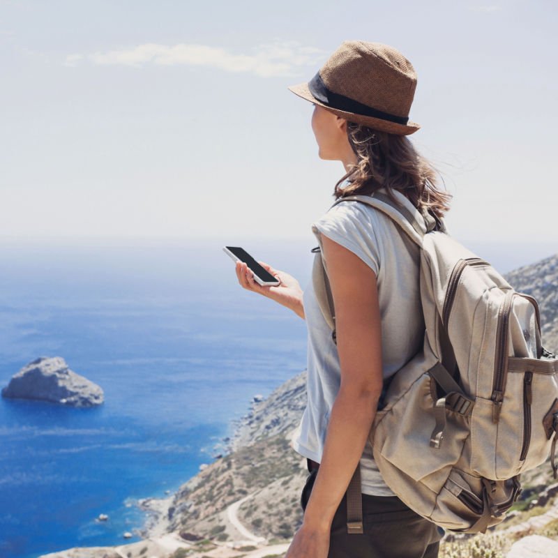 Hiking woman using smart phone, travel and active lifestyle concept