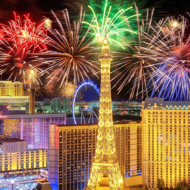 Las Vegas at night with fireworks going off over eiffel tower replica