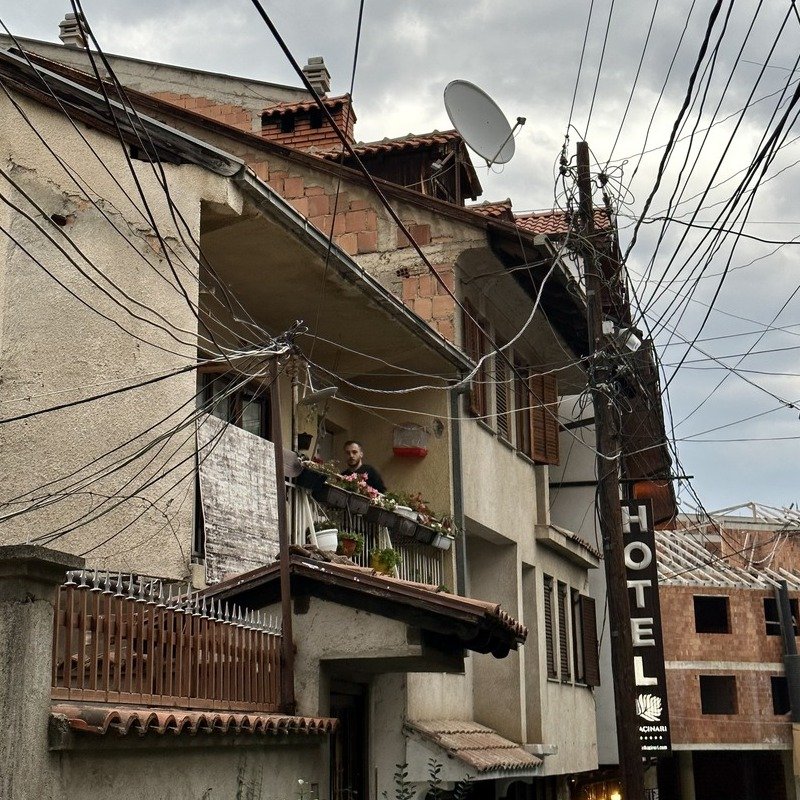 Exposed Power Cables Surrounding A Red Brick Building In Prizren, Kosovo