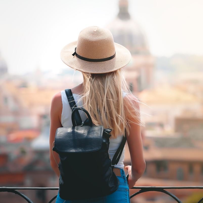 Solo female traveler looking out over a european city