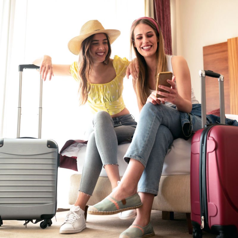 traveling girls and their luggage in a hotel room