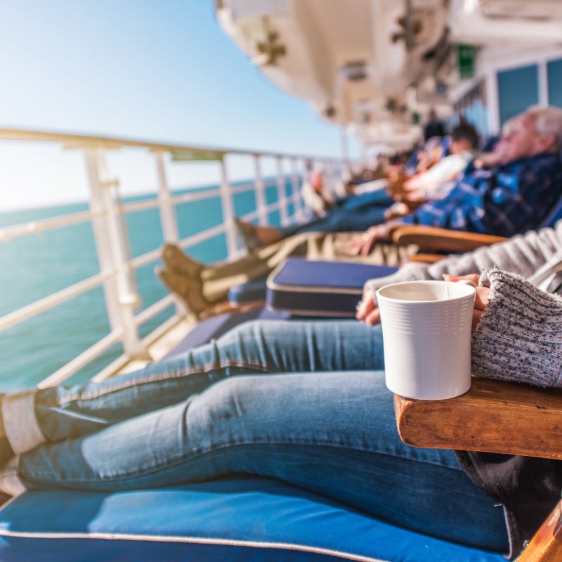 A row of cruise passengers relax on a stress-free vacation, a trend of 2023