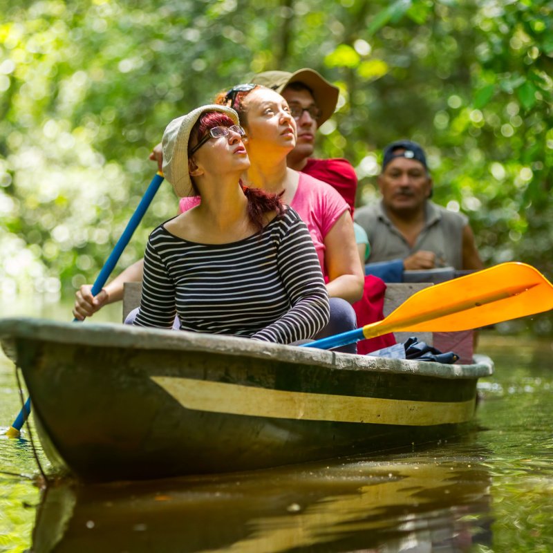 a group of tourists embark on a small boat tour