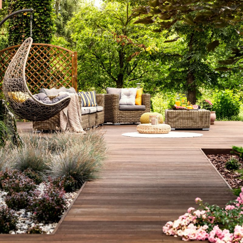 a wellness retreat is set up on a wooden deck with comfortable seating for attendees