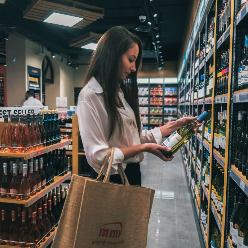 Woman in a liquor store shopping for wine. Taken at Town Square, Dubai, United Arab Emirates