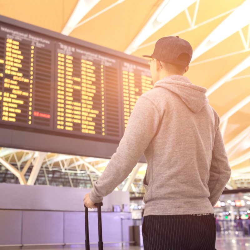 Man at Airport Watching Departures