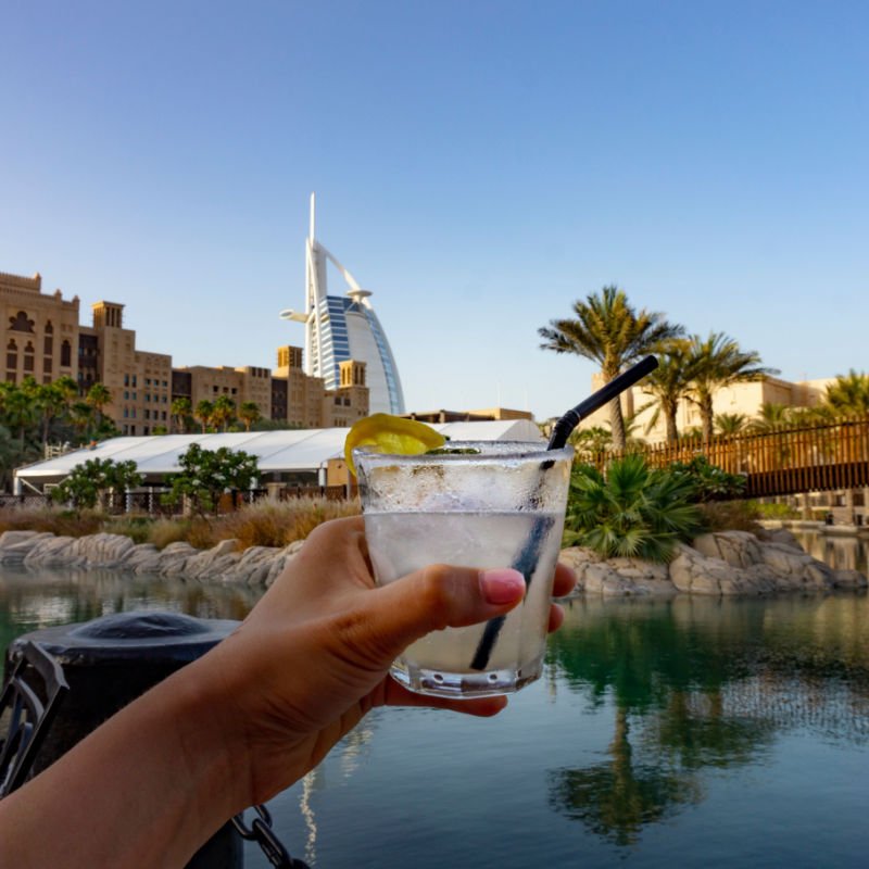 Drinking Caipirinha cocktail in Dubai in souk madinat jumeirah outside in a bar