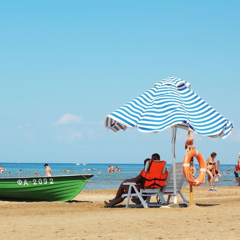 Sunbathers Enjoying A Day Out At The Beach In The Black Sea Province Of Bulgaria, South Eastern Europe, Balkan Peninsula