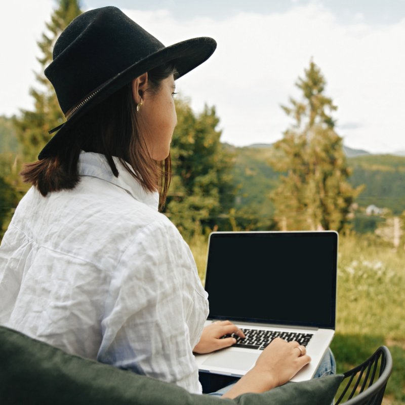 woman in the woods with laptop