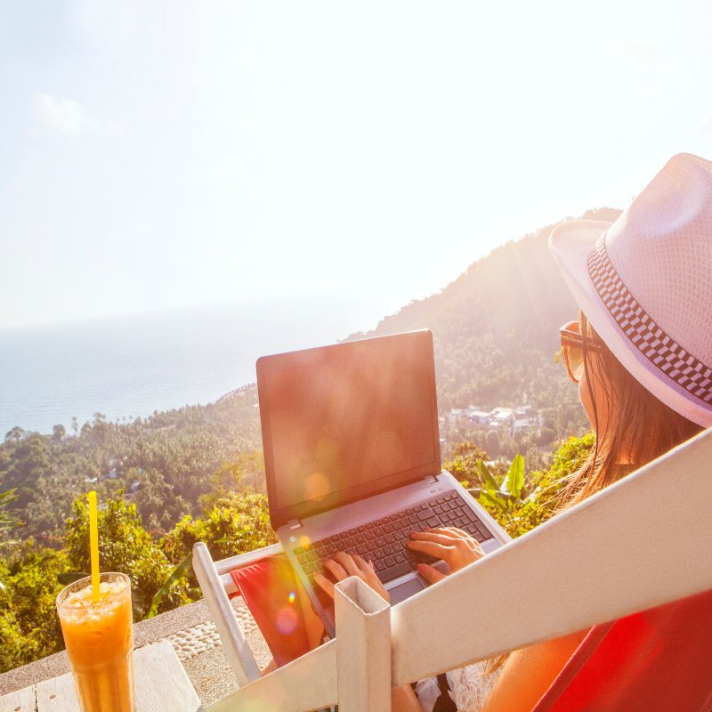 woman on laptop on the mountainside