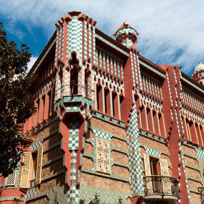 Casa Vicens is a modernist building located in Barcelona, in the district of Gracia. The building is covered in green and brick red striped patterns. 