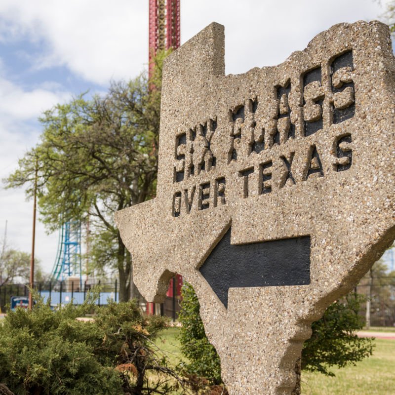 six flags over texas sign with arrow