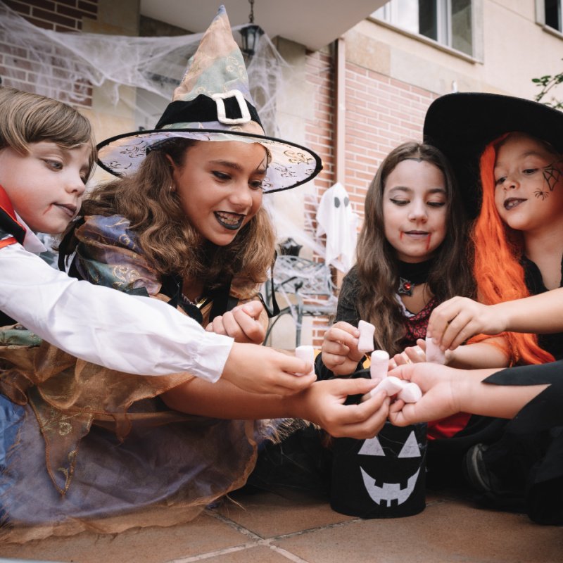 kids in costumes with halloween candy