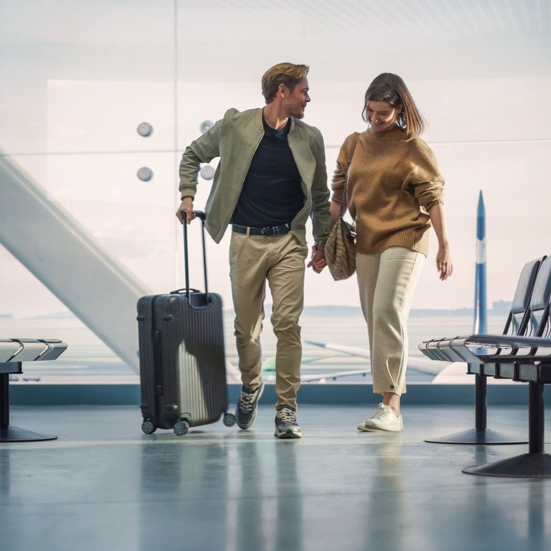 Young Happy Couple Pictured In The Airport, International Travel