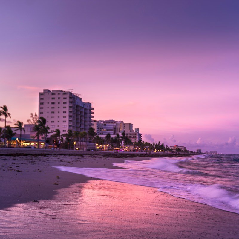 buildings next to beautiful beach at sunset