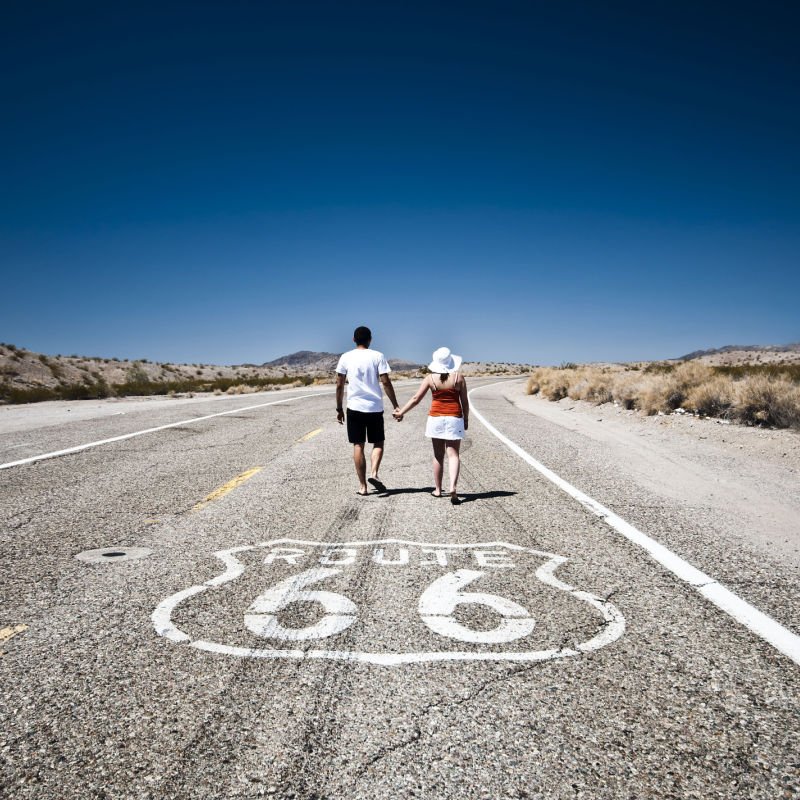 Route 66 - Couple of tourists walking on the famous highway