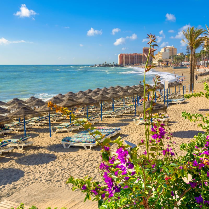 Lounge chairs on a beach in Malaga Spain