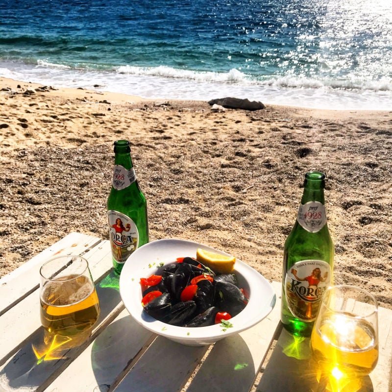 korca beer and mussels on the beach albania