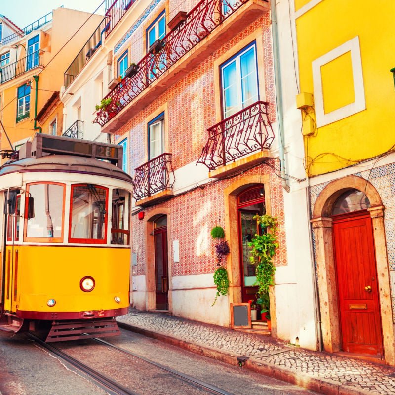 Yellow vintage tram on the street in Lisbon, Portugal. Famous travel destination