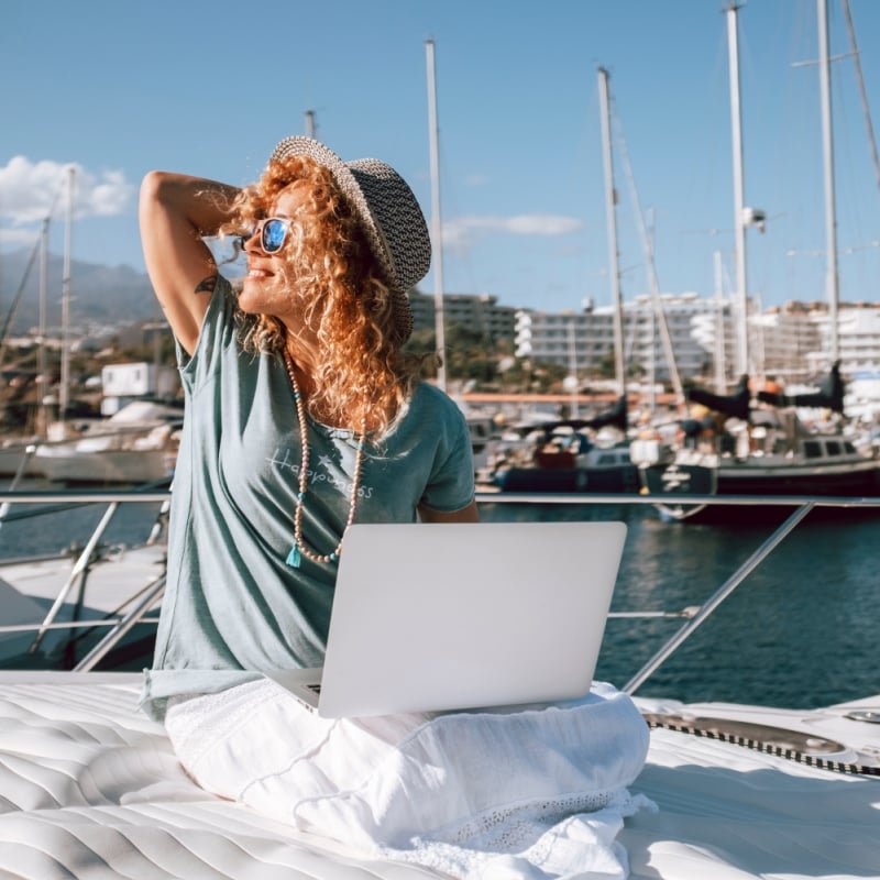 Digital nomad woman on a boat