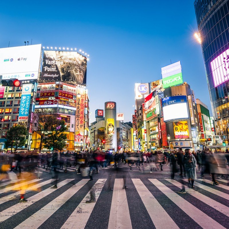 Pedestrians crossing the street at Shibuya crossing with motion blur