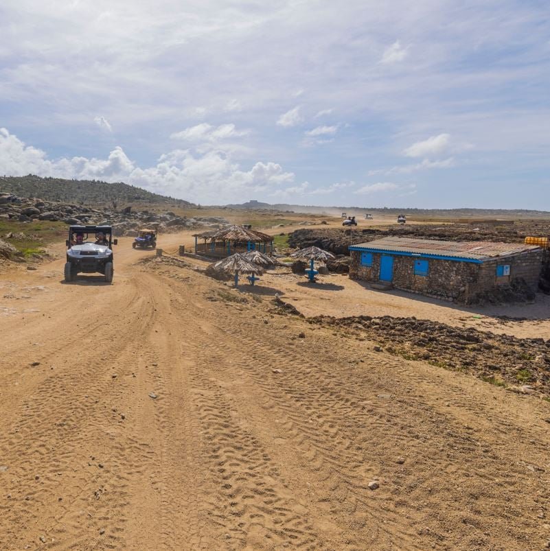 View of tourists on UTVs in the desert of Aruba