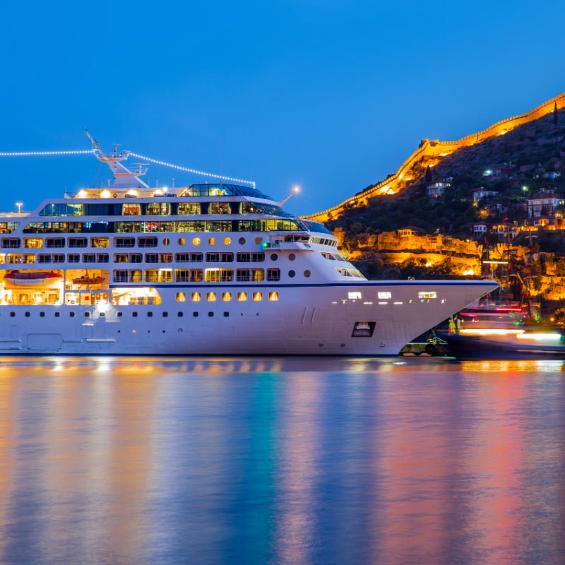 cruise ship at night lit up 