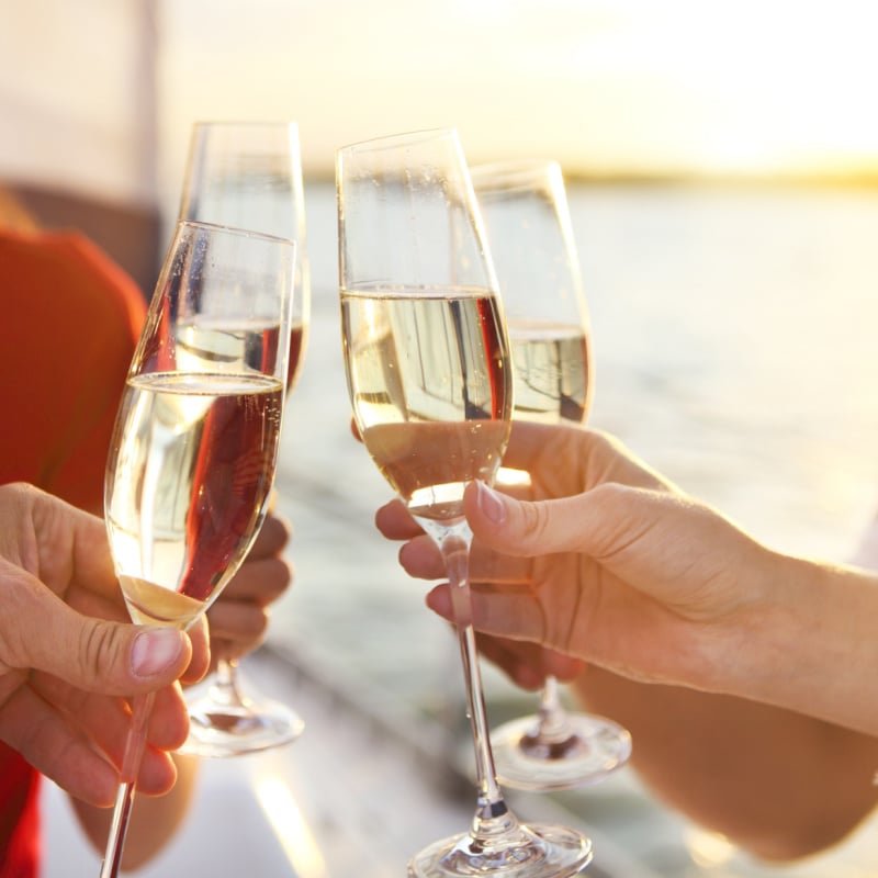 woman toasting champagne on cruise ship