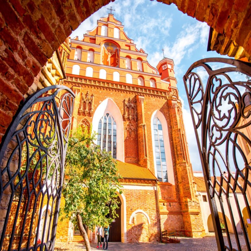 View from the gates on the beautiful Francis of Assisi gothic church in the old town of Vilnius city, Lithuania.