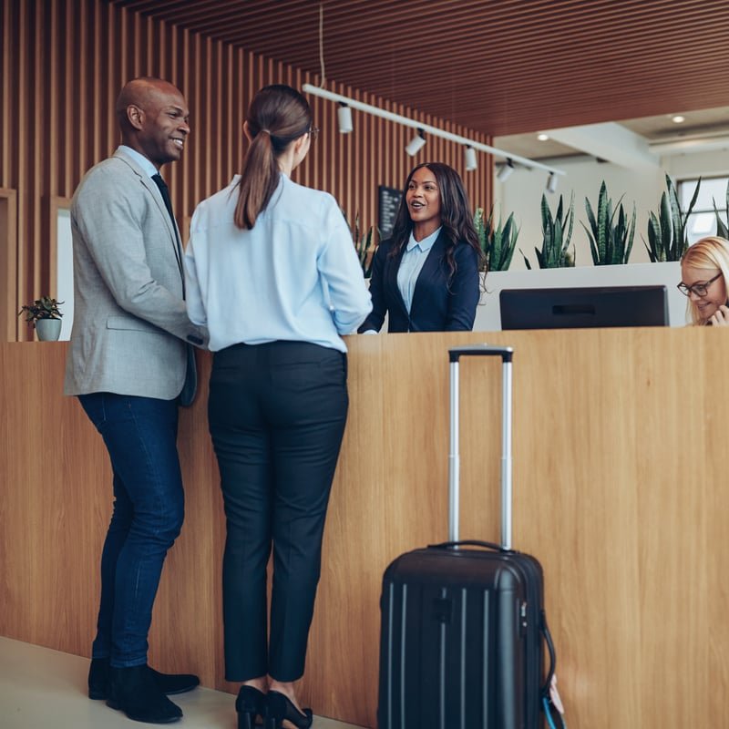 Couple Checking Into Hotel In An Unspecified Location