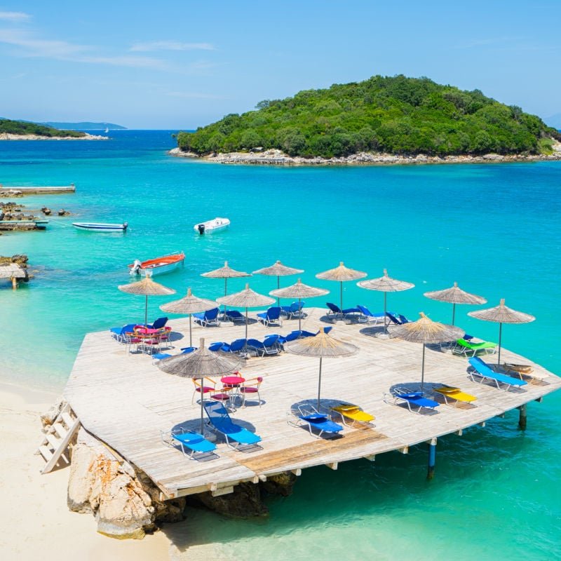 Ksamil Albania beach with blue water and umbrellas