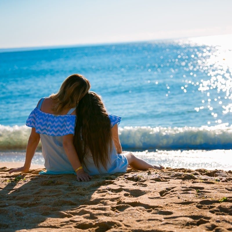 A Young Woman Who Is Also A Mother And Her Daughter Resting On A Beach In Bulgaria, On The Shores Of The Black Sea, Eastern Balkans, South Eastern Europe