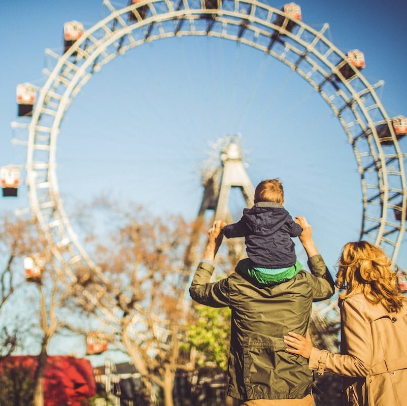 family in Vienna by the Ferris wheel on a sunny cool day