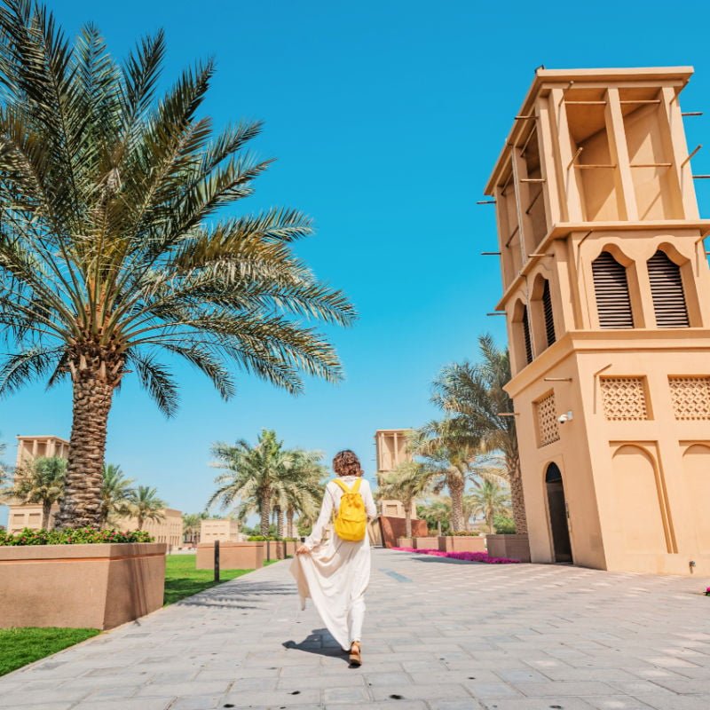 Woman walking in dubai with blue sky