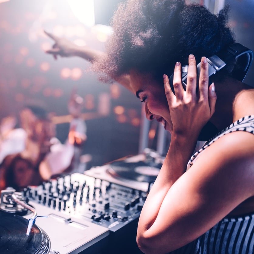 Young woman playing music at the club