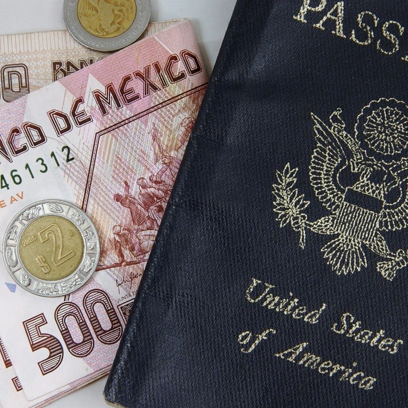 A Pile of Mexican Pesos Alongside a U.S. Passport