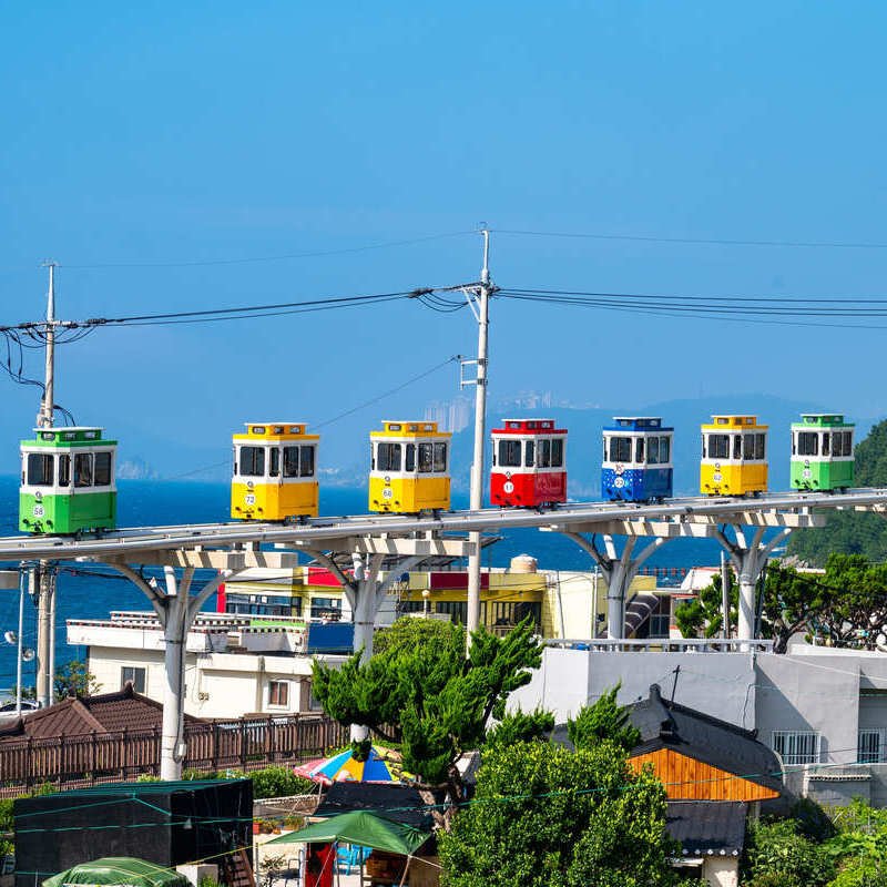 A Line Of Sky Capsules Traveling Along The Coast In Busan, South Korea, East Asia