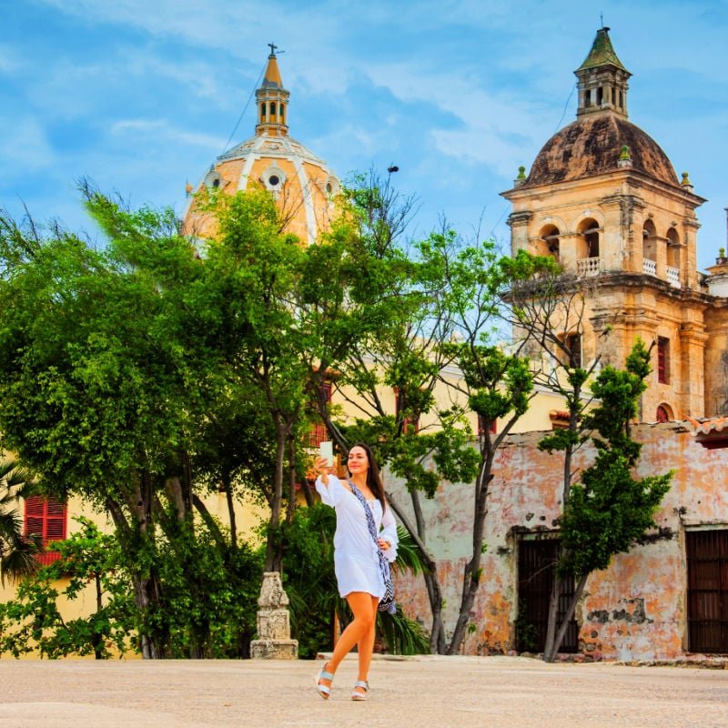 Beautiful woman taking selfies at the walls surrounding the colonial city of Cartagena de Indias