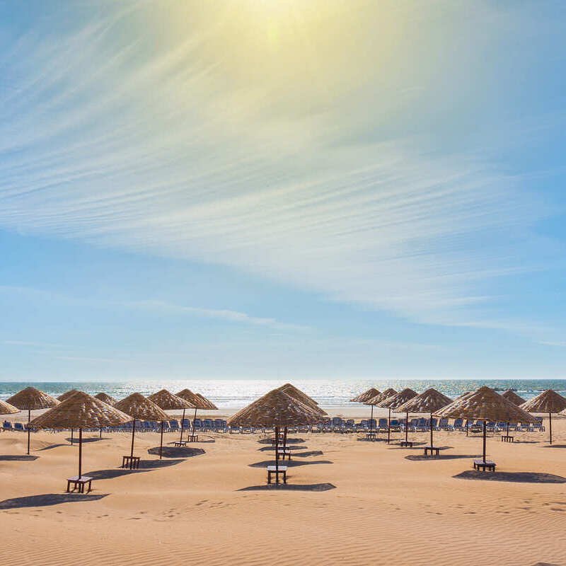 Beach Umbrellas On A Sandy Beach In Agadir, Morocco, North Africa