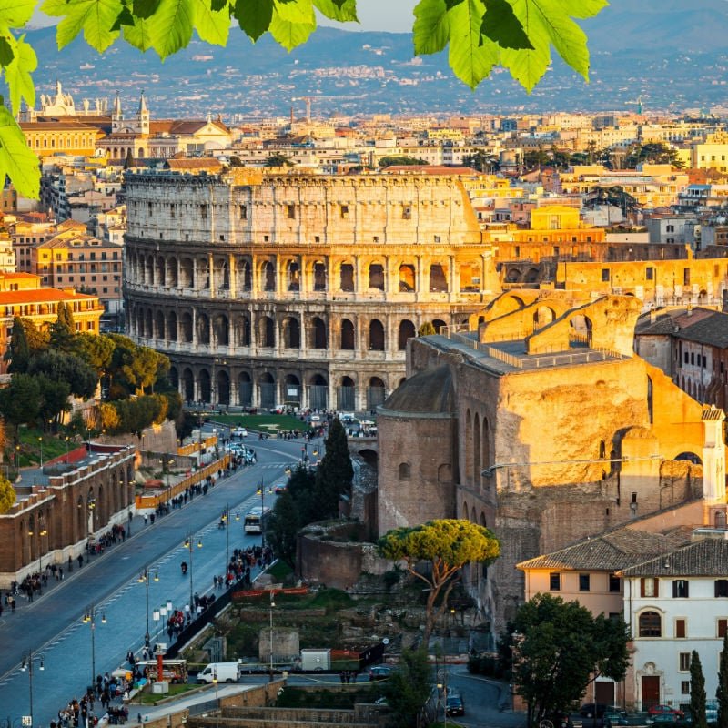 view of the colosseum in rome from a high vantage point at sunset