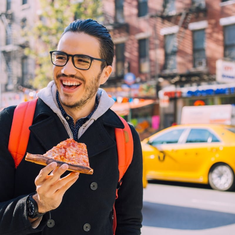 Man eating pizza in NYC